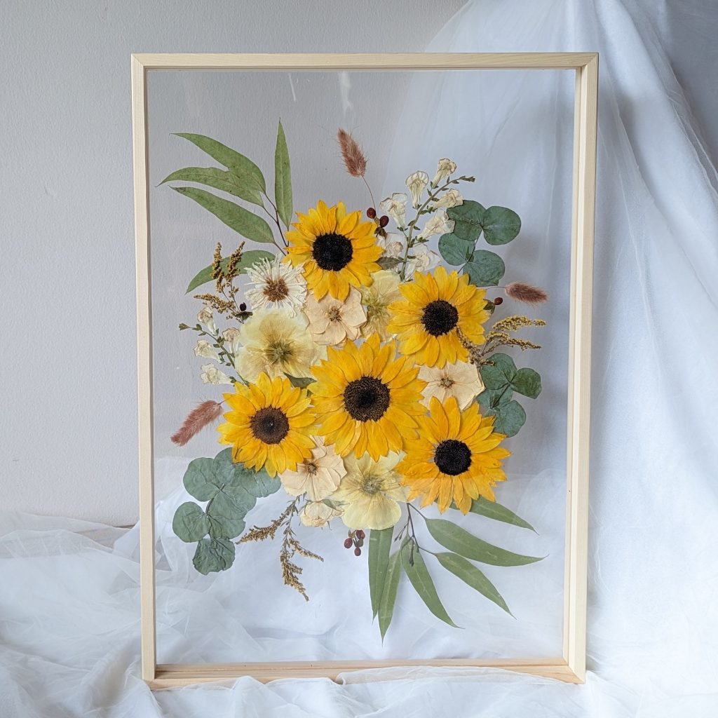 Wedding flower bouquet preserved in an A2 wooden frame featuring sunflowers